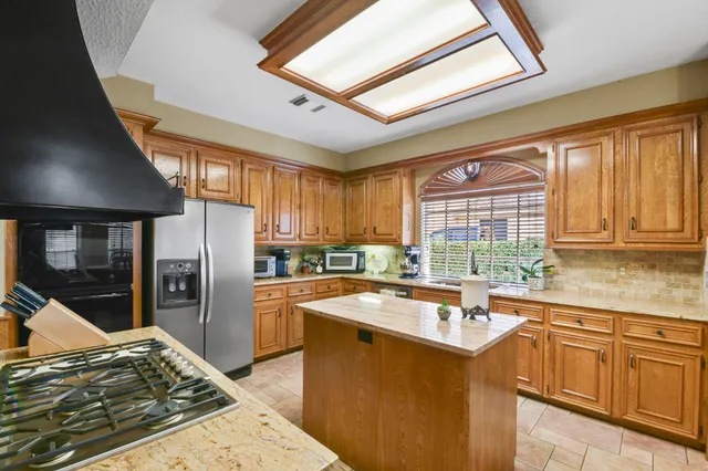 a kitchen filled counter top space and stainless steel appliances
