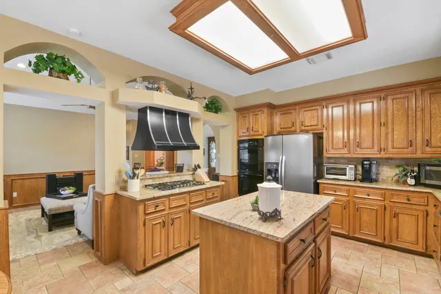 a kitchen with a sink stove and refrigerator