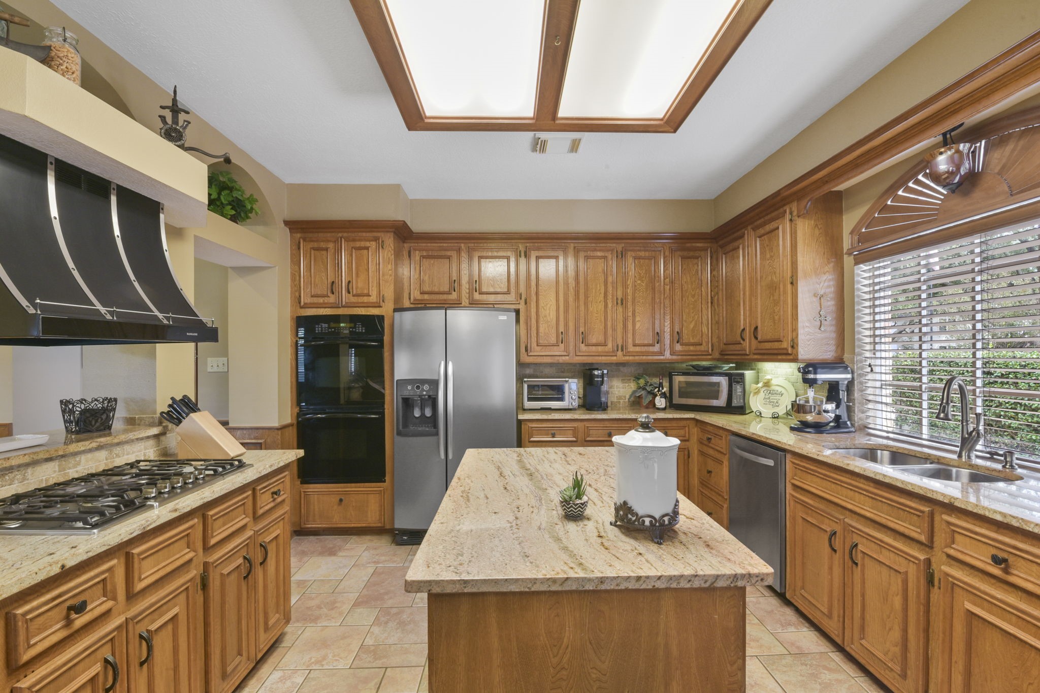 5827 Ashmere Lane Spring, TX 77379 - Photo 24 of 50 a kitchen with refrigerator a stove a sink and a window