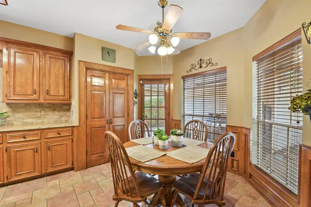 a view of a dining room with furniture wooden floor and chandelier