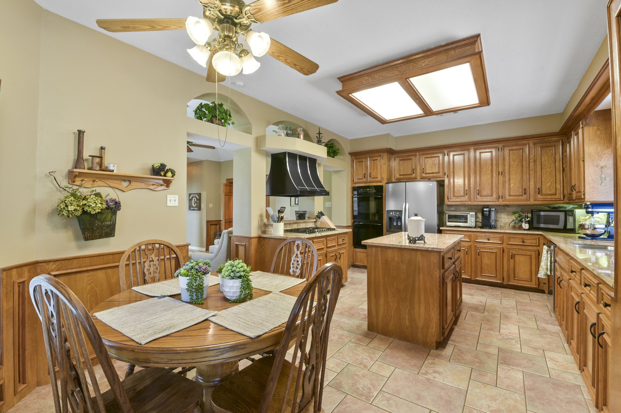5827 Ashmere Lane Spring, TX 77379 - Photo 28 of 50 a view of a dining room with furniture a kitchen and chandelier