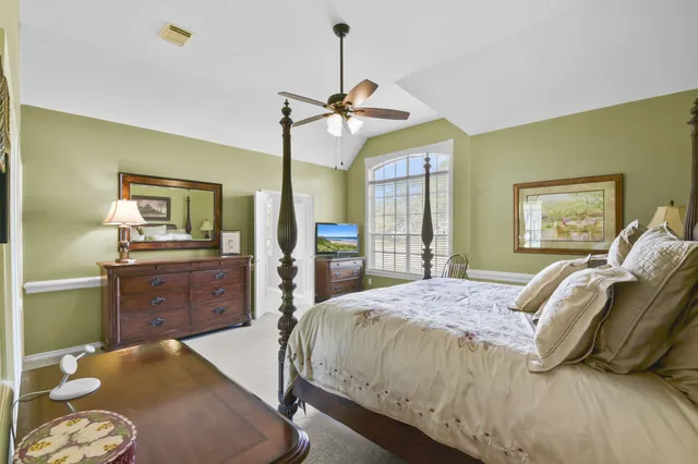 a bedroom with a bed and a dresser