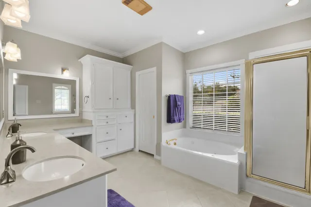 a bathroom with a tub sink and mirror