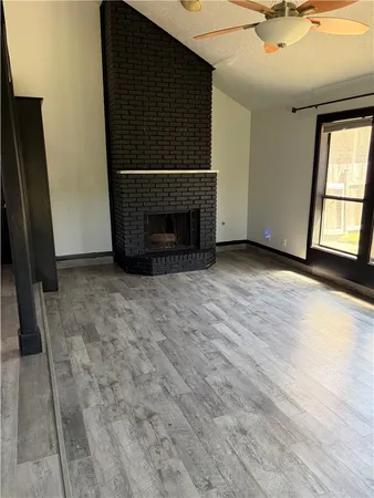 a view of a livingroom with a fireplace and a window