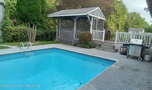 a view of backyard with deck and garden