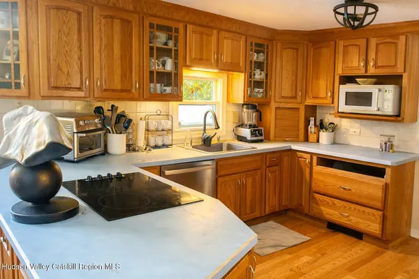 a kitchen with stainless steel appliances a sink a stove and a microwave