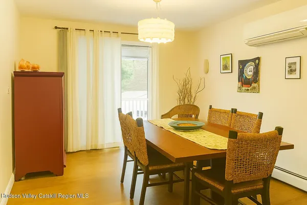 a view of a dining room with furniture and a window