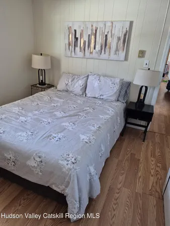 a bedroom with a bed and a night stand