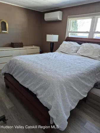 a bedroom with a bed and window