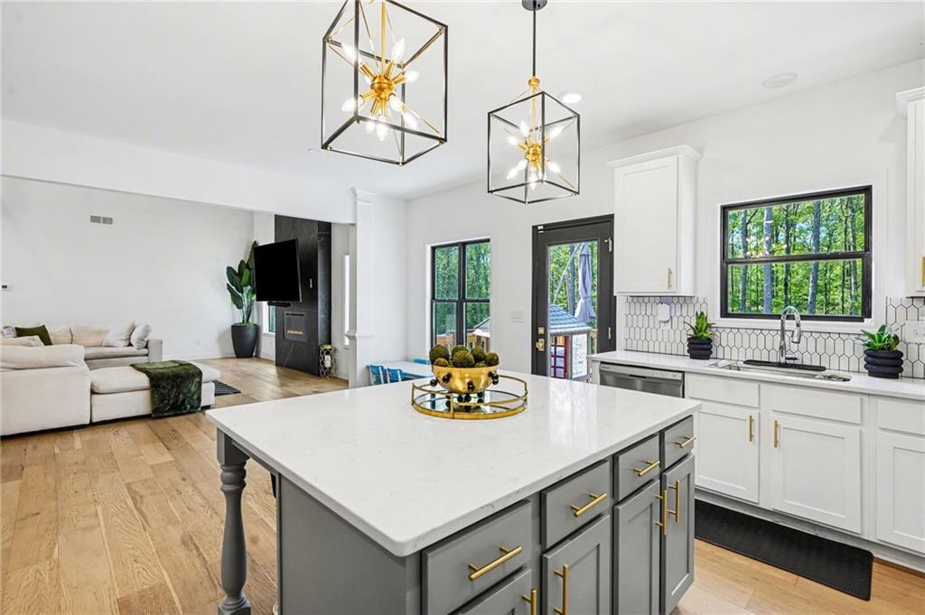 130 Serenity Way Conyers, GA 30013 - Photo 15 of 34 a kitchen with stainless steel appliances a table chairs and chandelier