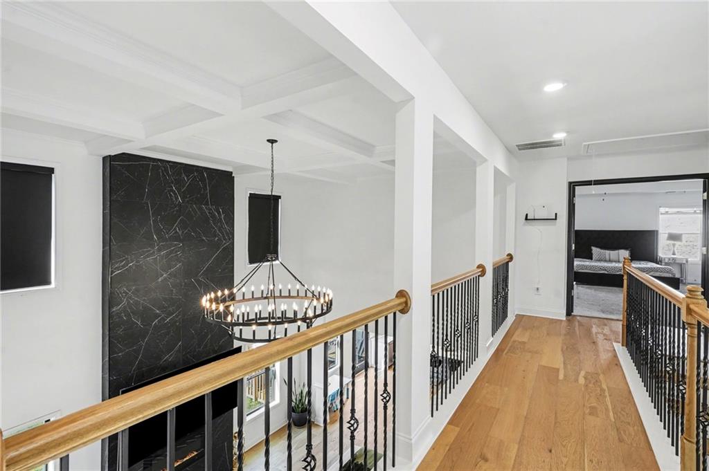 130 Serenity Way Conyers, GA 30013 - Photo 20 of 34 a view of a hallway with wooden floor and staircase