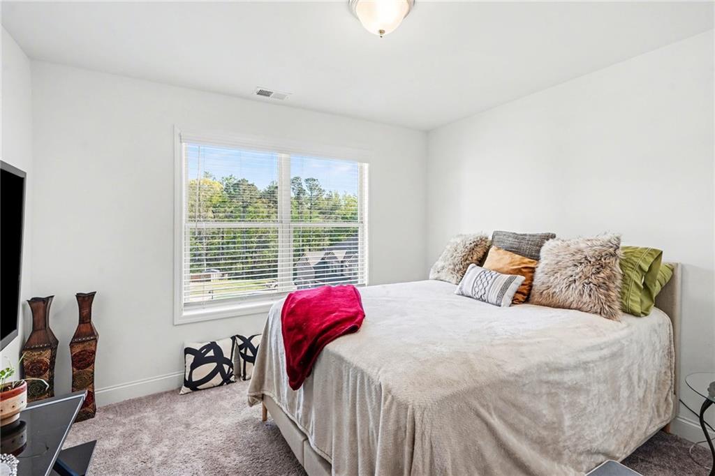 130 Serenity Way Conyers, GA 30013 - Photo 21 of 34 a bedroom with a bed and a window