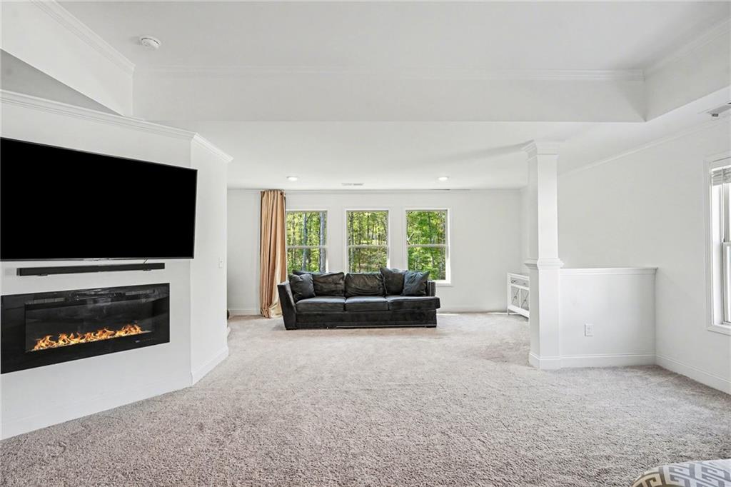 130 Serenity Way Conyers, GA 30013 - Photo 25 of 34 a living room with furniture a flat screen tv and a fireplace