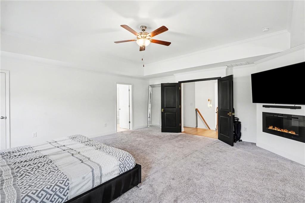 130 Serenity Way Conyers, GA 30013 - Photo 27 of 34 a bedroom with a bed and a flat screen tv