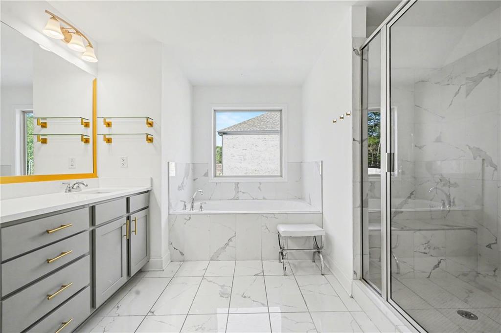 130 Serenity Way Conyers, GA 30013 - Photo 28 of 34 a spacious bathroom with a bathtub and a shower