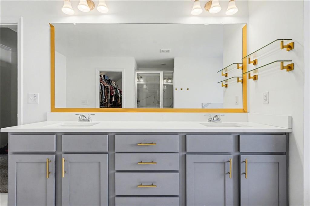 130 Serenity Way Conyers, GA 30013 - Photo 29 of 34 a bathroom with a sink and a mirror