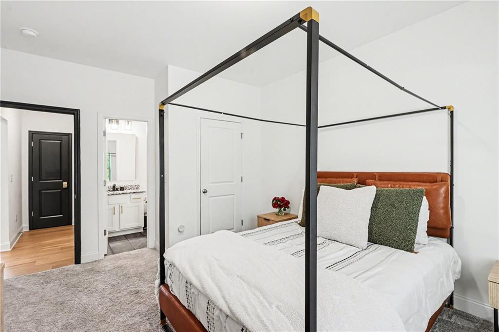 130 Serenity Way Conyers, GA 30013 - Photo 30 of 34 a bed room with a bed and a mirror