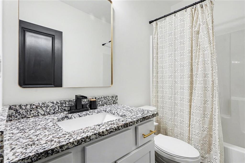 130 Serenity Way Conyers, GA 30013 - Photo 31 of 34 a bathroom with a granite countertop sink and a mirror