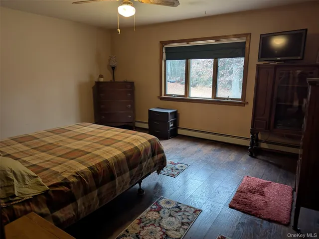 a bedroom with a bed dresser and a window