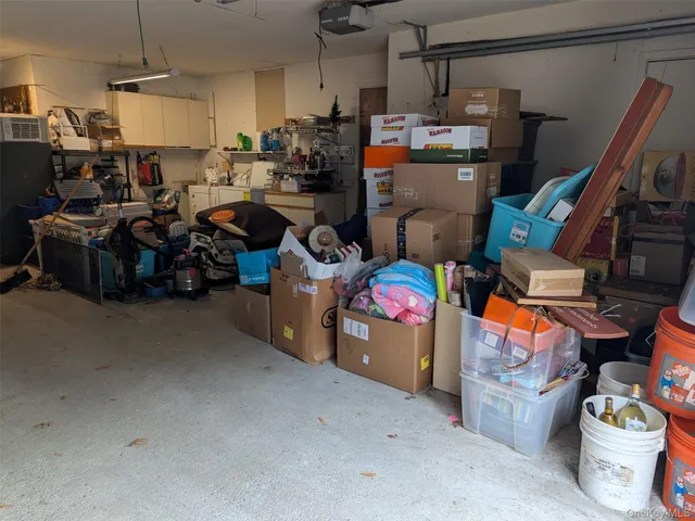 a storage room with lots of clutter and cars