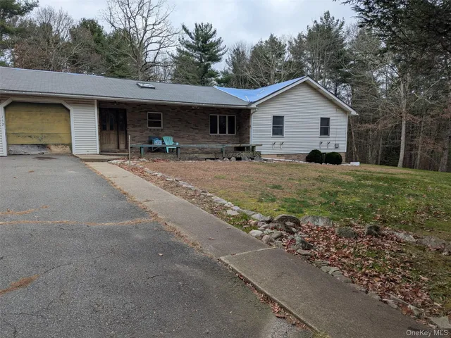 a view of a house with backyard and trees