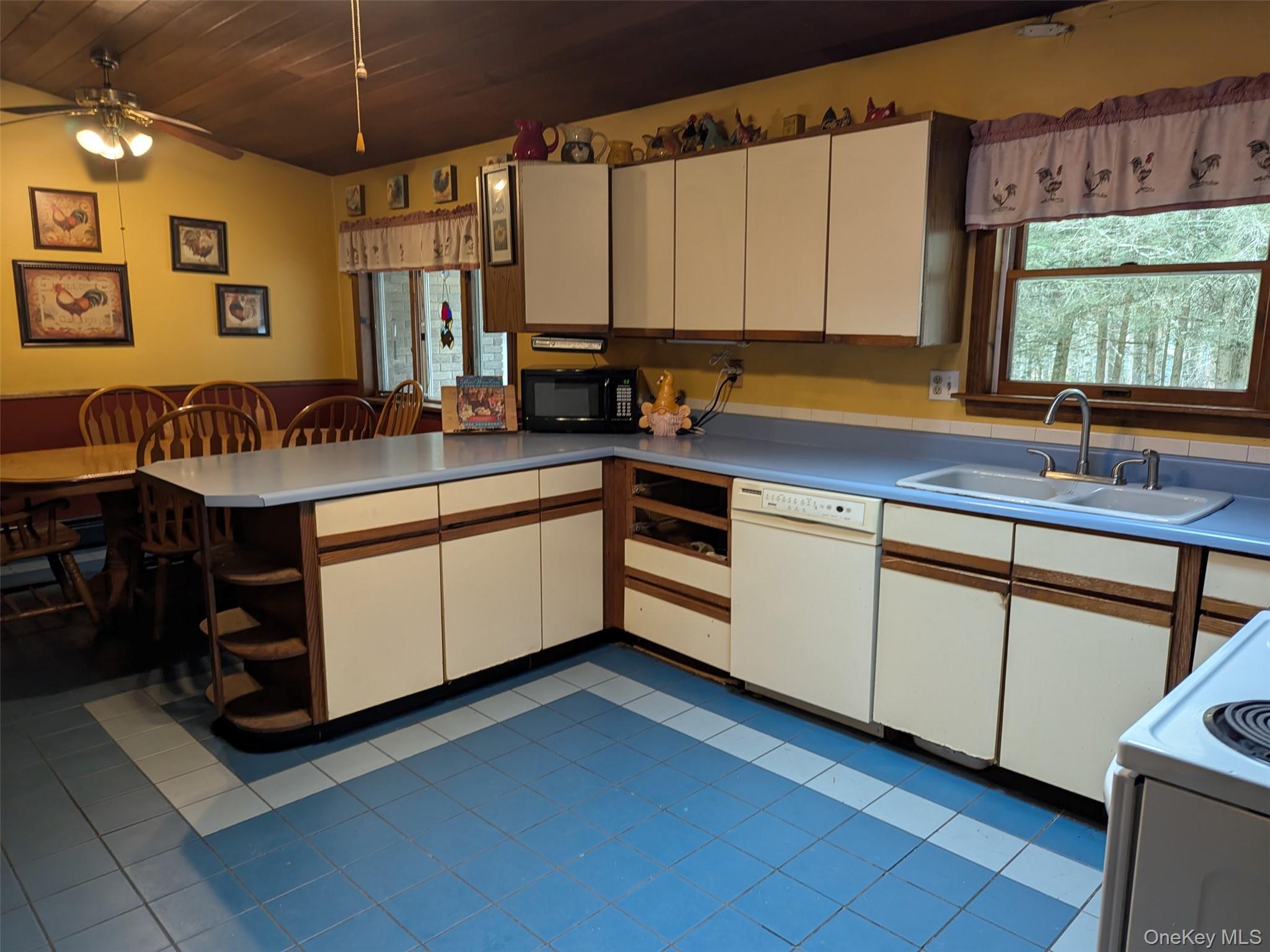 152 Old Forestburg Road Sparrowbush, NY 12780 - Photo 10 of 32 a kitchen with stainless steel appliances granite countertop a sink a stove and a refrigerator
