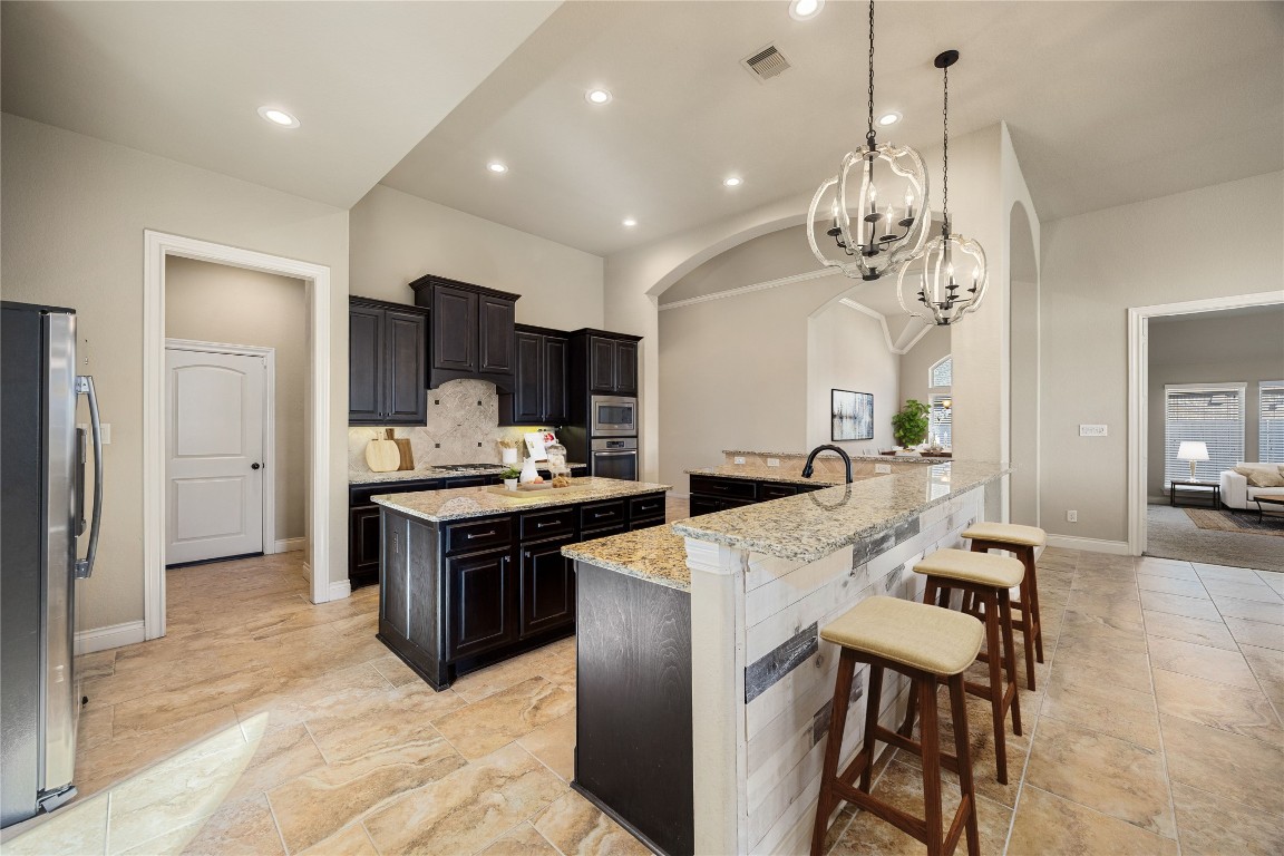23211 Ruspino Shores Place Katy, TX 77493 - Photo 12 of 39 a large kitchen with a table and chairs