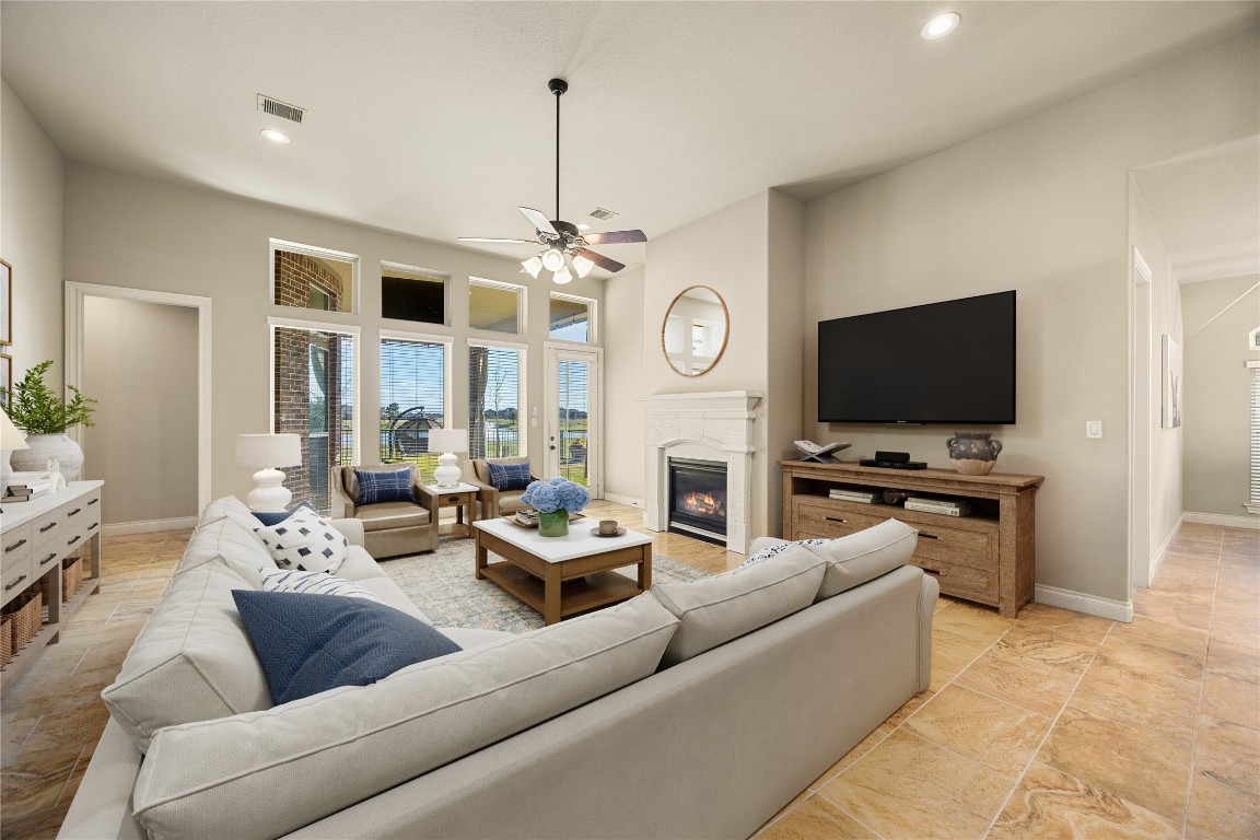 23211 Ruspino Shores Place Katy, TX 77493 - Photo 15 of 39 a living room with furniture and a flat screen tv