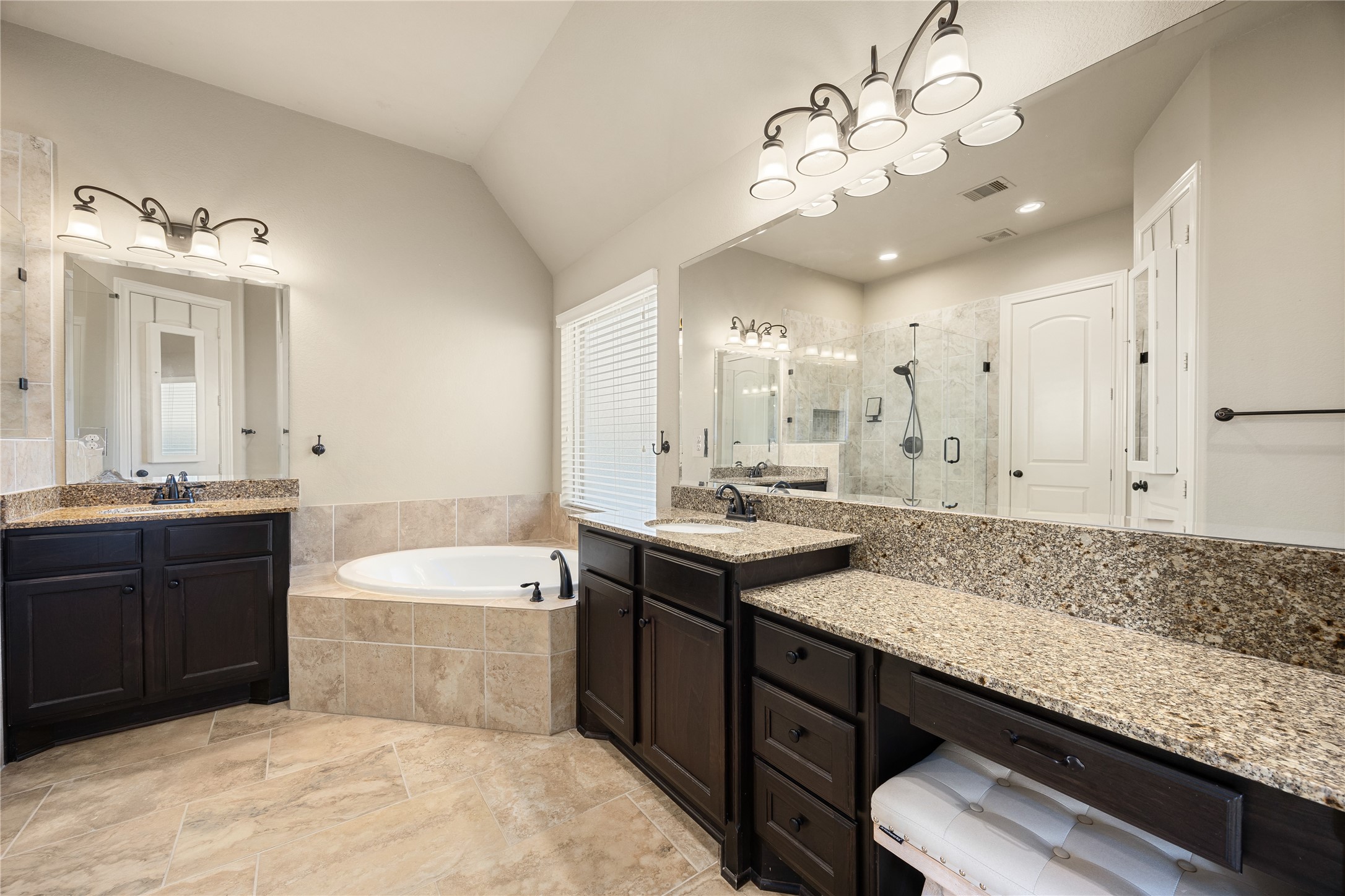 23211 Ruspino Shores Place Katy, TX 77493 - Photo 20 of 39 a spacious bathroom with a granite countertop sink a toilet a mirror and bathtub
