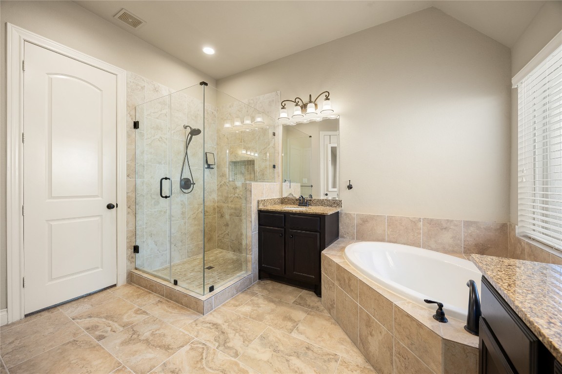 23211 Ruspino Shores Place Katy, TX 77493 - Photo 21 of 39 a spacious bathroom with a tub sink shower and mirror