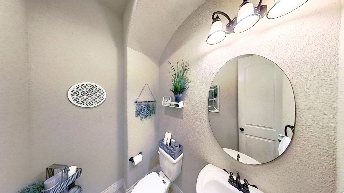 23211 Ruspino Shores Place Katy, TX 77493 - Photo 22 of 39 a bathroom with a toilet a sink and mirror