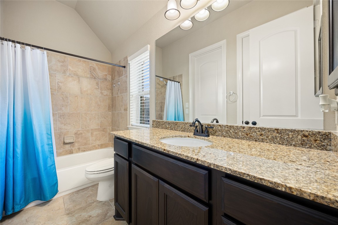 23211 Ruspino Shores Place Katy, TX 77493 - Photo 24 of 39 a bathroom with a granite countertop sink a toilet and bathtub