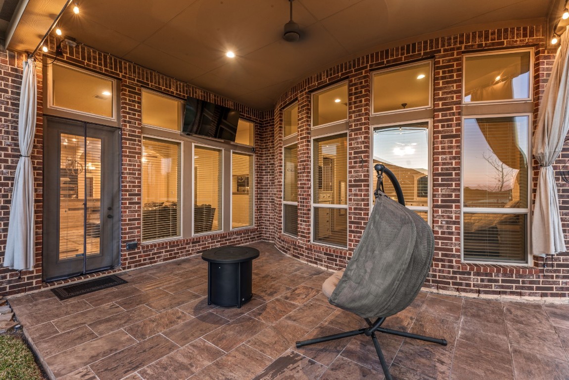 23211 Ruspino Shores Place Katy, TX 77493 - Photo 28 of 39 a view of a brick house with a chairs and table in a patio