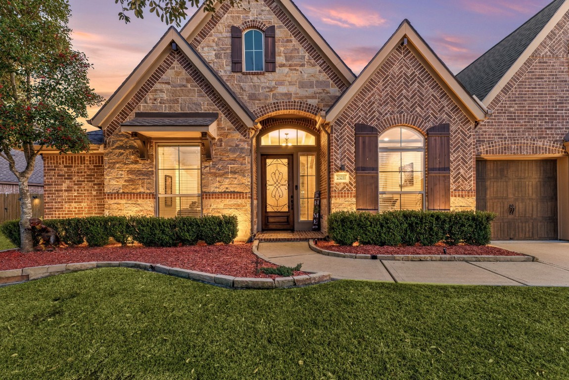 23211 Ruspino Shores Place Katy, TX 77493 - Photo 3 of 39 a front view of a house with a yard