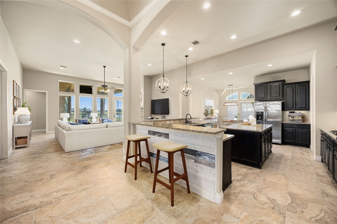 23211 Ruspino Shores Place Katy, TX 77493 - Photo 9 of 39 a large white kitchen with a large counter top appliances and cabinets