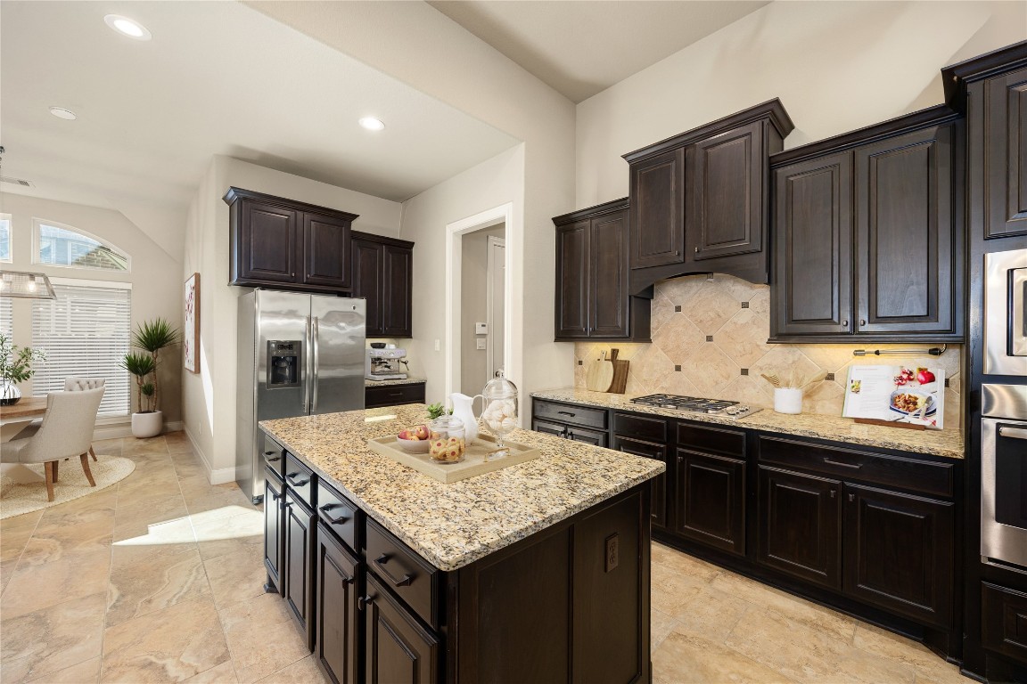 23211 Ruspino Shores Place Katy, TX 77493 - Photo 39 of 39 a kitchen with granite countertop a sink and cabinets