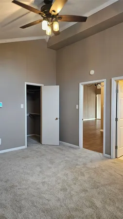 a view of an empty room with a ceiling fan