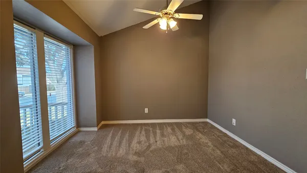 a view of room with window and ceiling fan