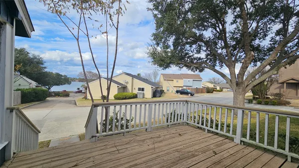 a view of deck of house with wooden floor and fence