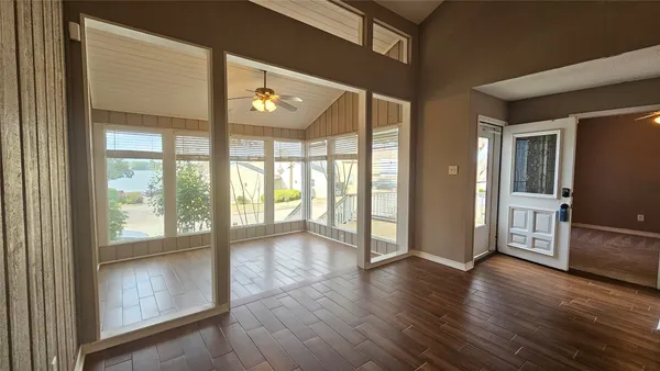 a view of an entryway with wooden floor and door