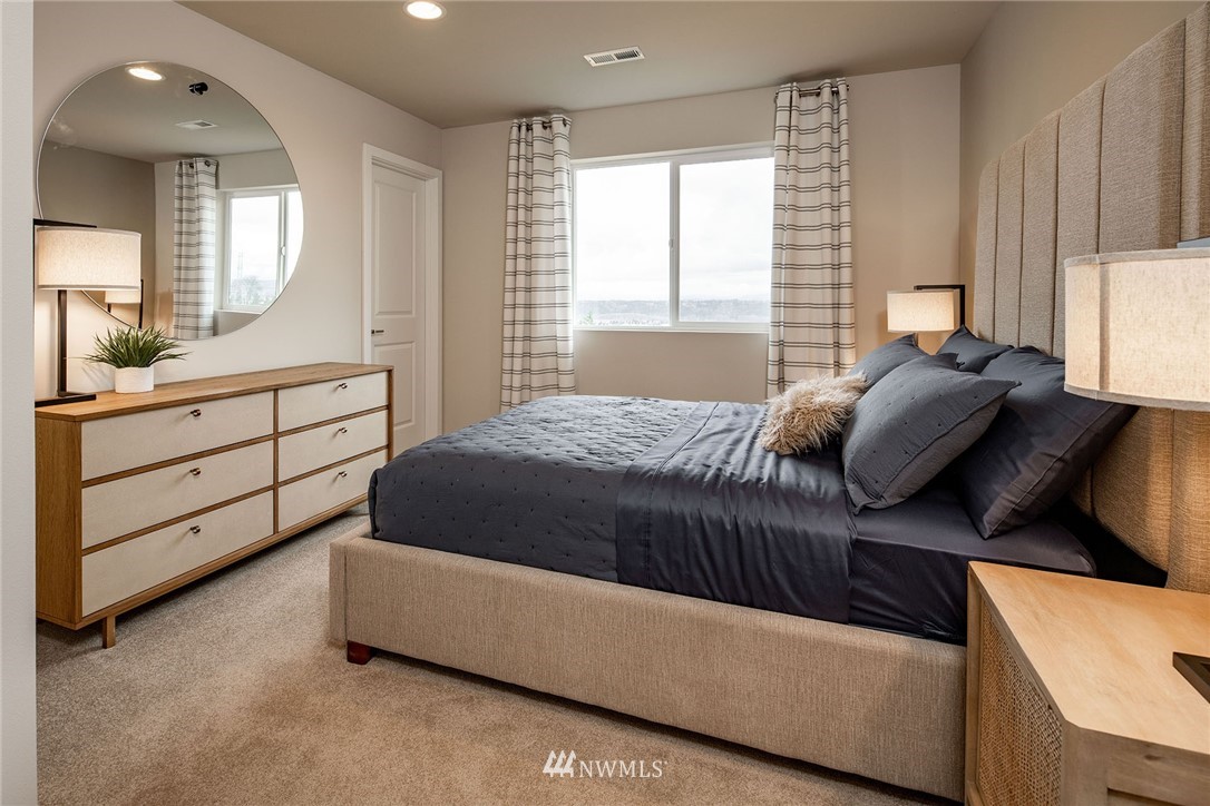 11 215th Street Southeast, Unit 1 Bothell, WA 98021 - Photo 17 of 18 a bedroom with a bed and a dresser