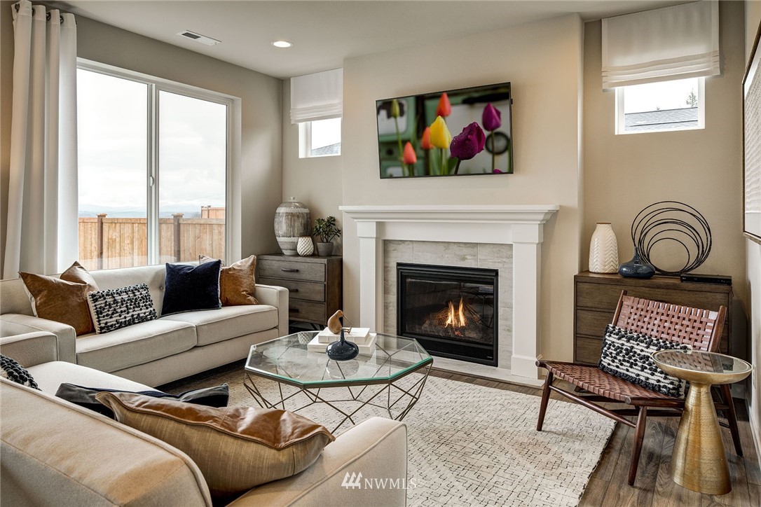 11 215th Street Southeast, Unit 1 Bothell, WA 98021 - Photo 6 of 18 a living room with furniture a rug a fireplace and window