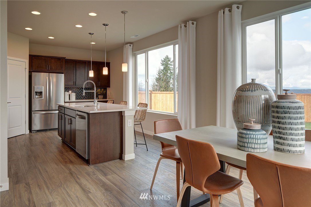 11 215th Street Southeast, Unit 1 Bothell, WA 98021 - Photo 8 of 18 a dining room with furniture and a large window