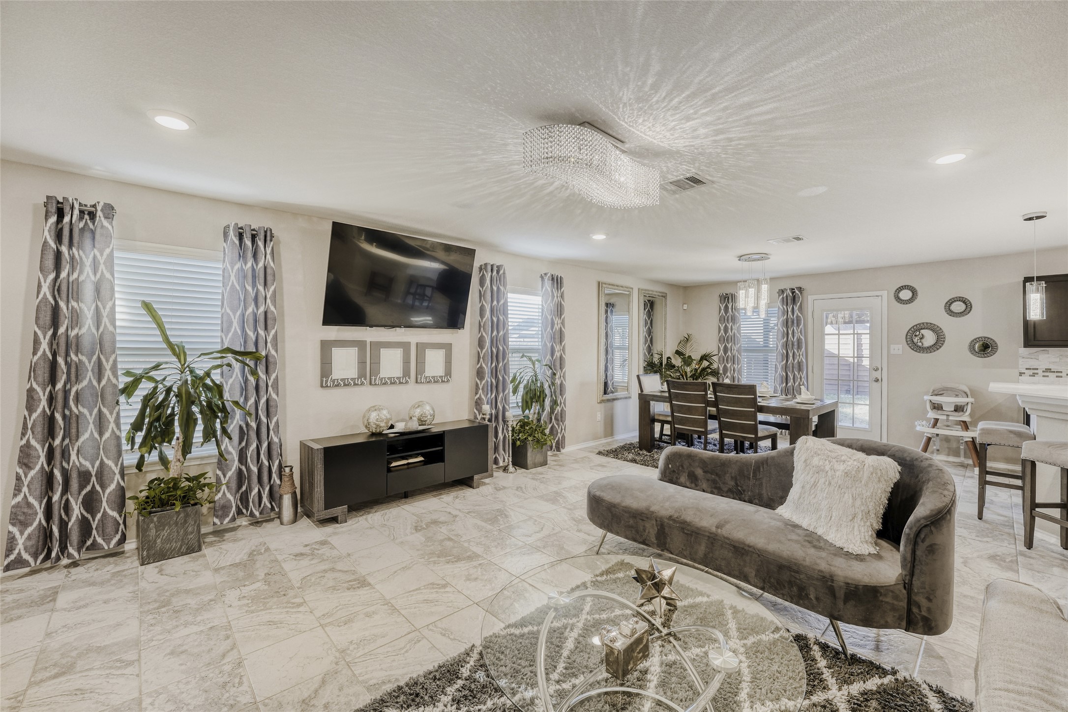 13604 Vigilance Street Manor, TX 78653 - Photo 12 of 28 a living room with furniture and a flat screen tv