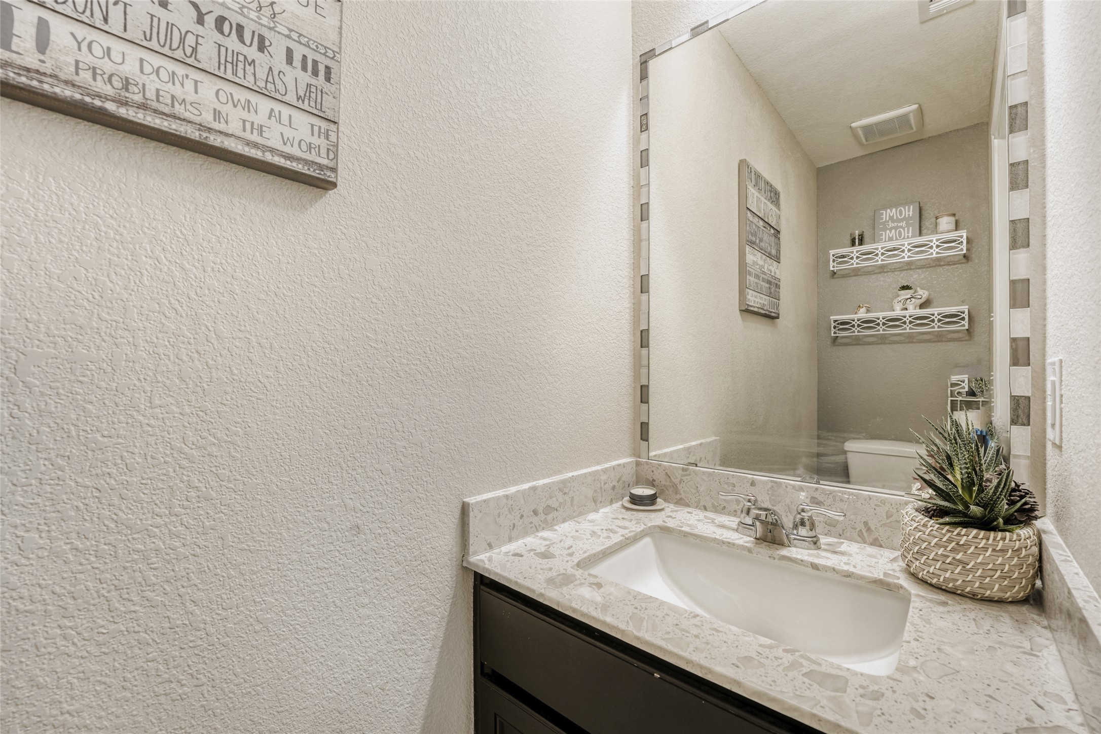 13604 Vigilance Street Manor, TX 78653 - Photo 13 of 28 a bathroom with a granite countertop sink and a mirror