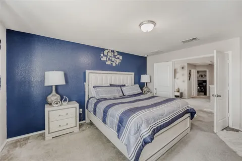 a bedroom with a bed and a lamp on table