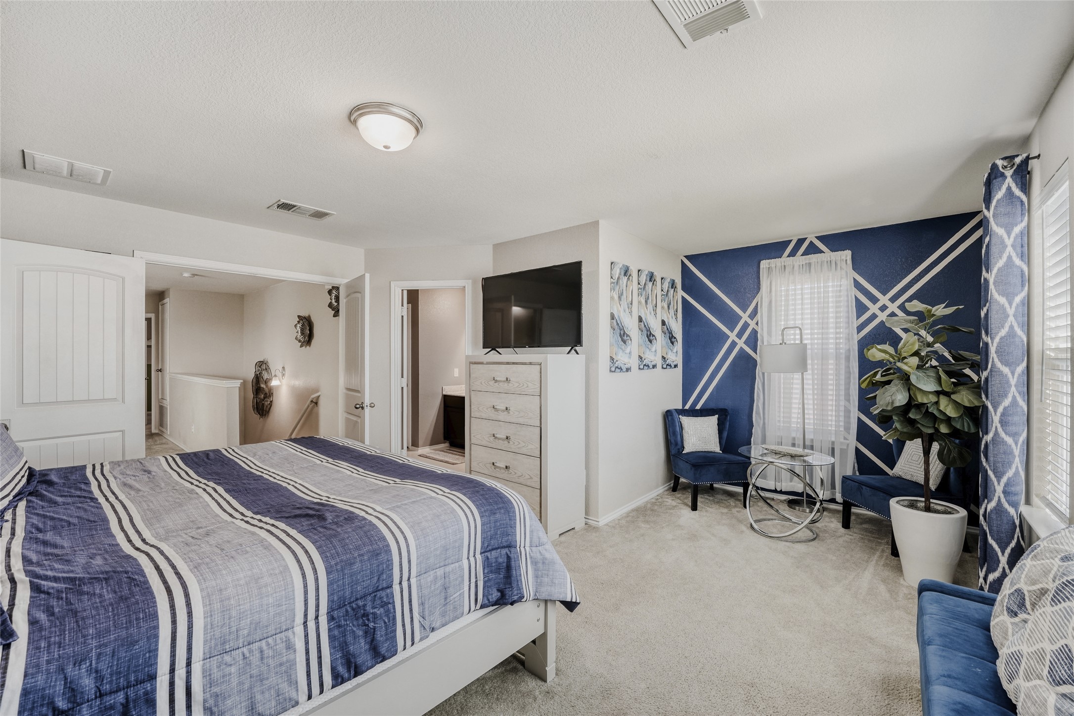 13604 Vigilance Street Manor, TX 78653 - Photo 15 of 28 a bedroom with a bed and a flat screen tv