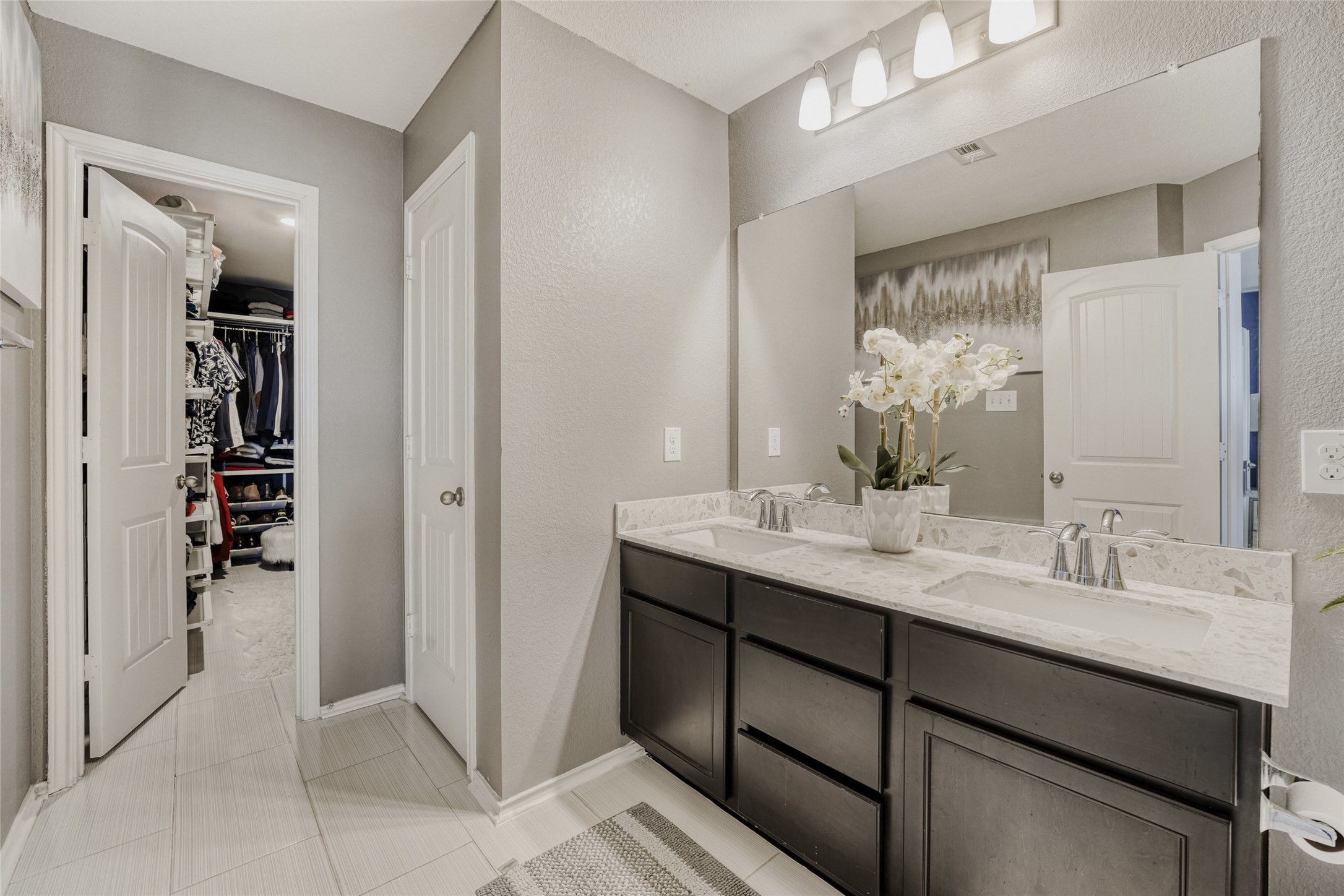 13604 Vigilance Street Manor, TX 78653 - Photo 17 of 28 a bathroom with a double vanity sink a and mirror