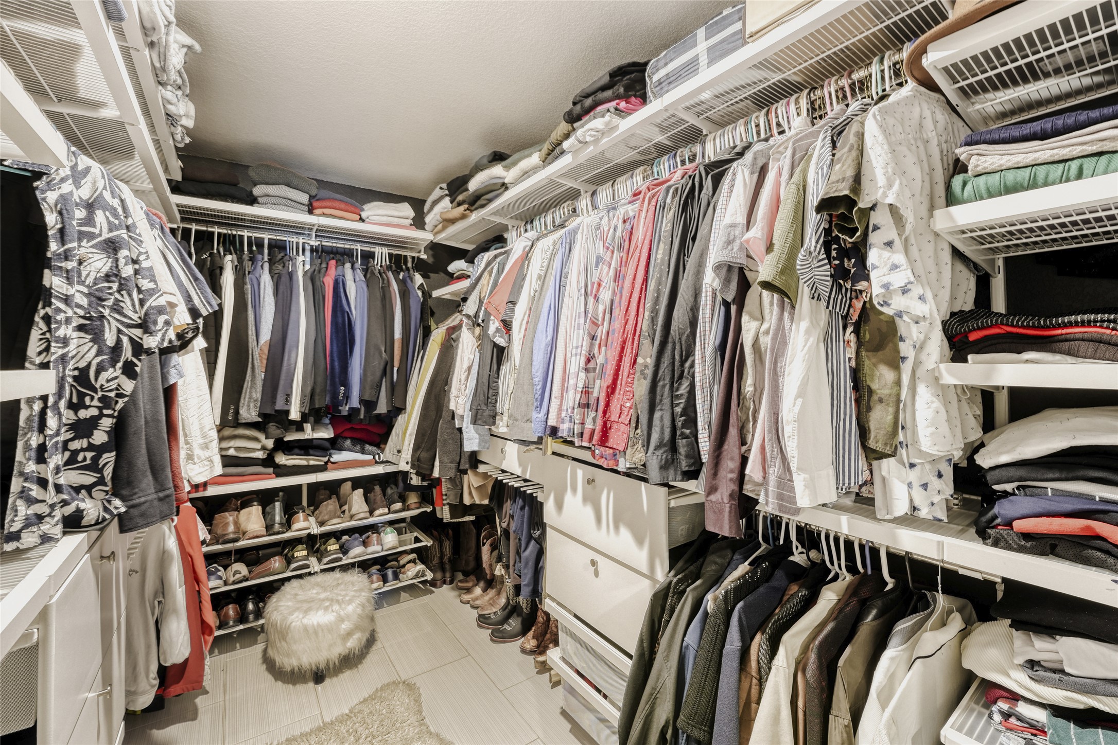13604 Vigilance Street Manor, TX 78653 - Photo 19 of 28 a view of walk in closet with clothes and shoes
