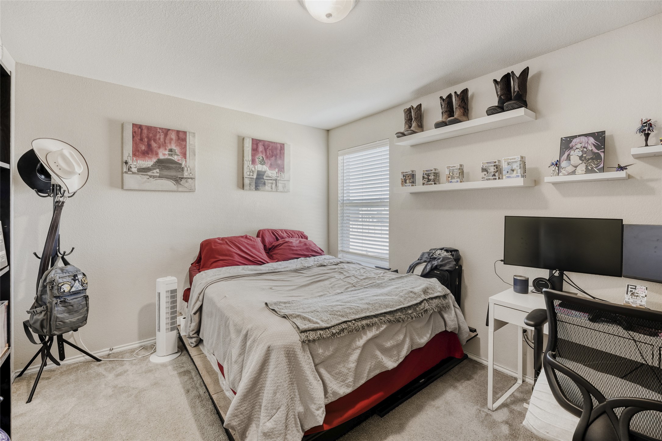 13604 Vigilance Street Manor, TX 78653 - Photo 20 of 28 a bedroom with a bed and a flat screen tv